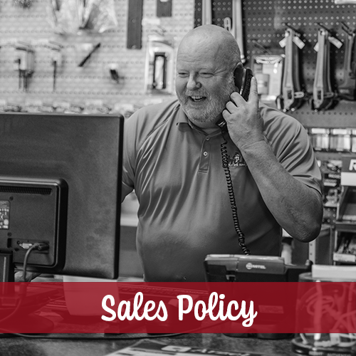 male employee smiling on phone at counter